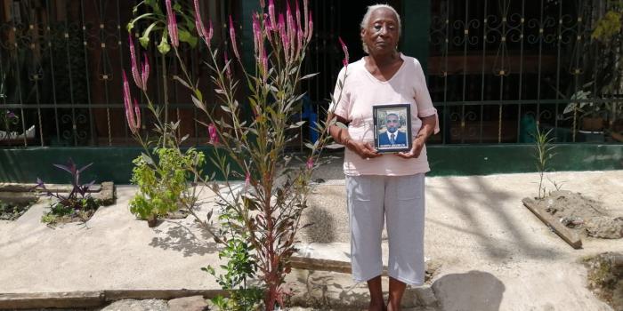 Eva Chaverra with her son's, Gilberto Ledezma's portrait. He was dessapeared and killed.